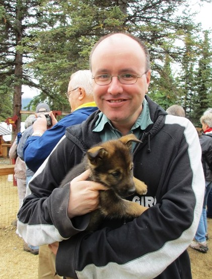 Erik Tomren with Alaskan husky puppy.