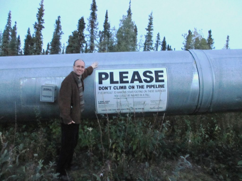 Erik Tomren in front of the Trans-Alaska oil pipeline.
