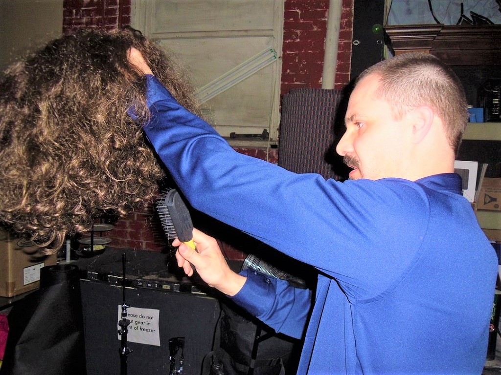 Drummer Scott Tatman, of Seattle-based Black Sabbath tribute Bastard of Reality, preparing his wig for performance.