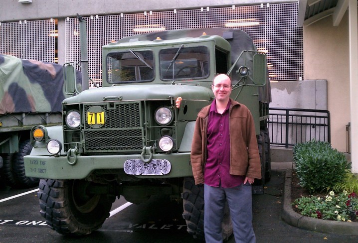Erik Tomren in front of a military vehicle at Seattle's 2011 ZomBcon.