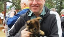 Erik Tomren with Alaskan husky puppy.