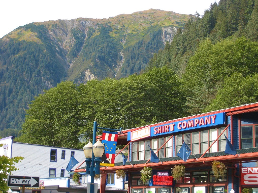 Tourist shops line downtown Juneau, with Mount Juneau in the background.